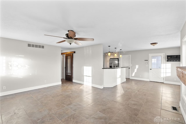 interior space featuring baseboards, visible vents, and a ceiling fan