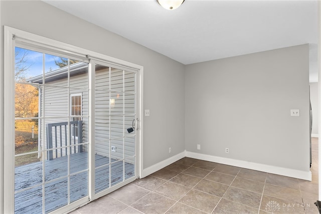 tiled empty room with baseboards