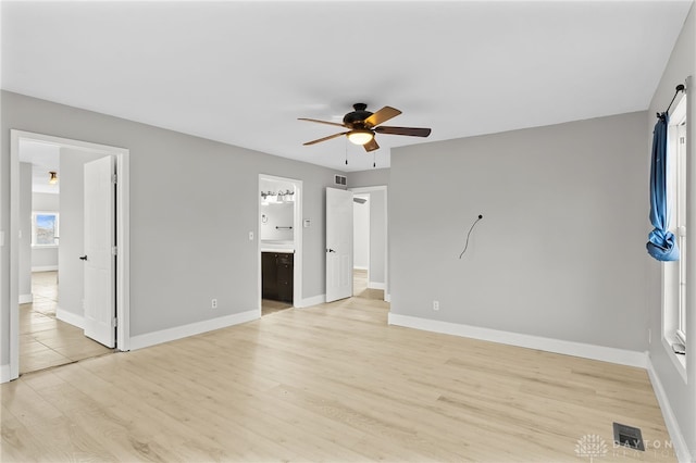 unfurnished bedroom featuring light wood-style floors, visible vents, and baseboards