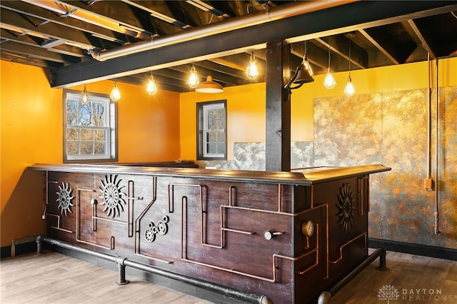 bar with beamed ceiling, wood finished floors, and baseboards