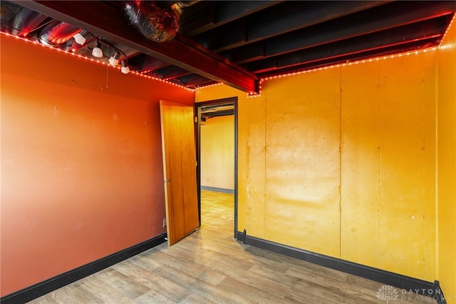 interior space featuring light wood-style flooring and baseboards