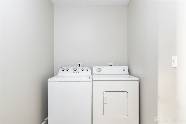 clothes washing area with laundry area and washer and clothes dryer