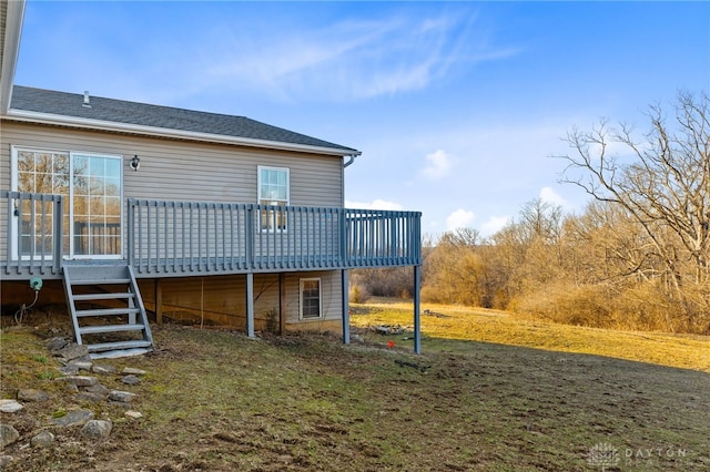 rear view of property with a lawn and a deck