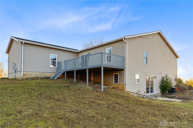 rear view of property with stairs, a lawn, and a wooden deck