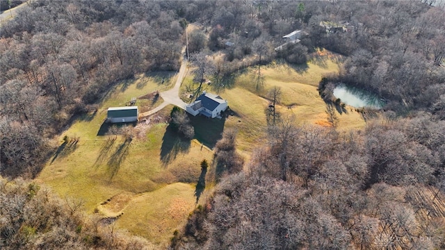 bird's eye view with a wooded view