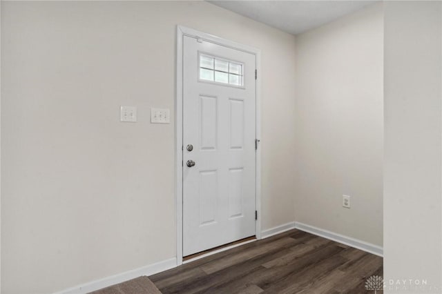 entryway featuring baseboards and dark wood finished floors