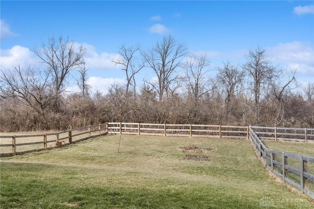 view of yard featuring a rural view and fence