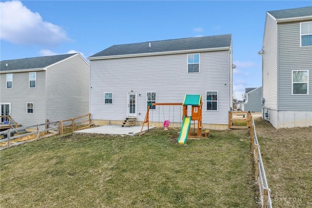 rear view of house featuring entry steps, a patio area, a fenced backyard, and a yard