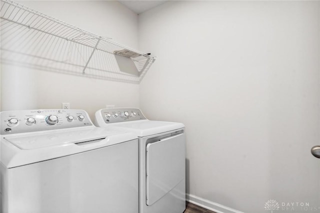 laundry area with washing machine and dryer, laundry area, and baseboards