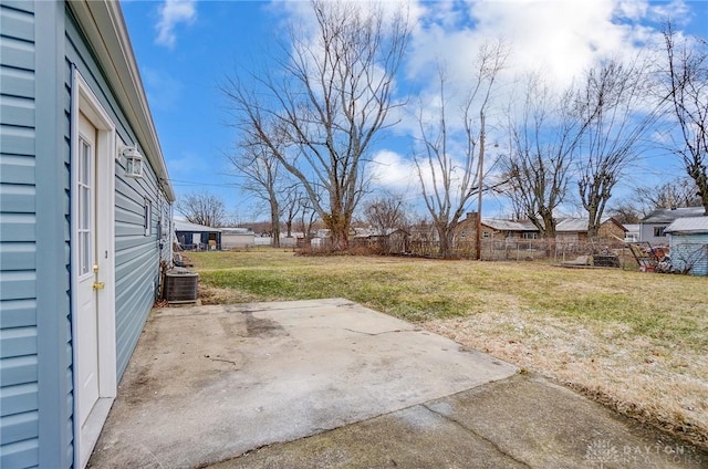 view of yard with fence, central AC, and a patio