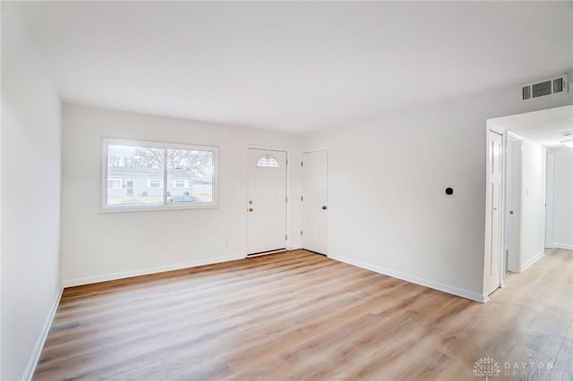 entryway with light wood-style flooring, visible vents, and baseboards