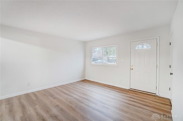 entrance foyer featuring light wood-style flooring and baseboards