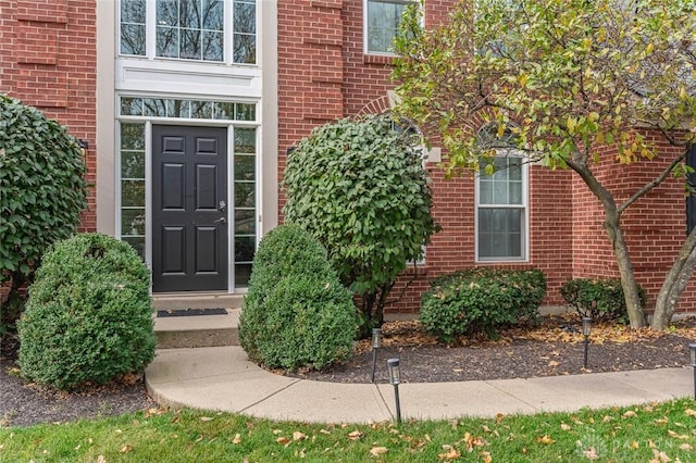 view of exterior entry with brick siding