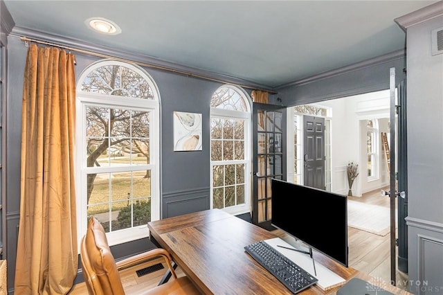 office with ornamental molding, wood finished floors, and visible vents