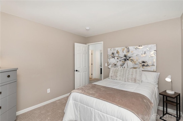 bedroom with light carpet and baseboards