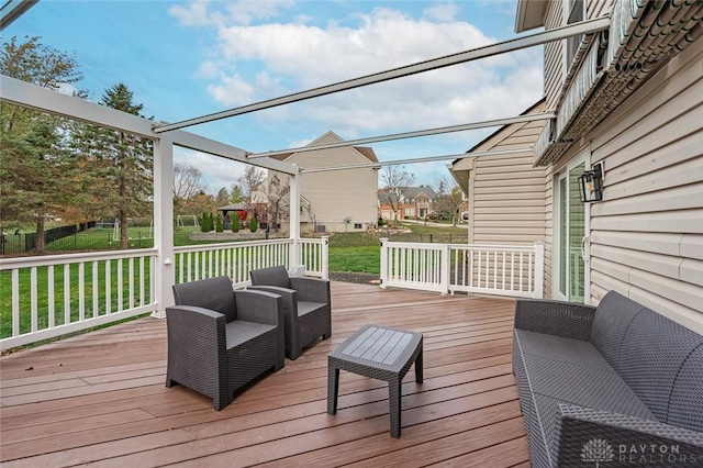 wooden terrace with a yard and an outdoor living space