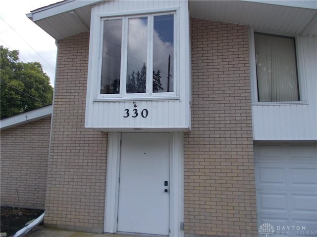 entrance to property with brick siding