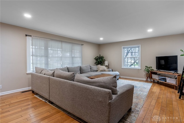 living area with recessed lighting, baseboards, visible vents, and light wood finished floors