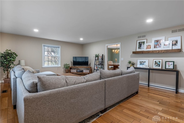 living area with light wood-type flooring, visible vents, and recessed lighting