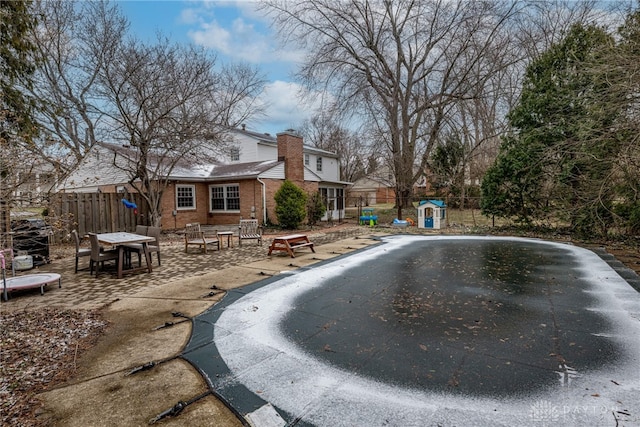 view of swimming pool with a patio area and fence