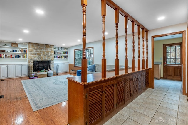 interior space featuring plenty of natural light, a fireplace, light wood-style flooring, and recessed lighting