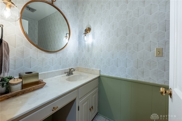 bathroom featuring a wainscoted wall and vanity