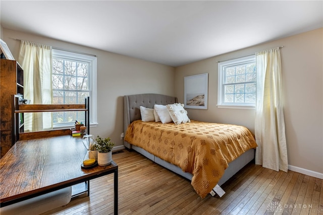 bedroom with baseboards and hardwood / wood-style floors