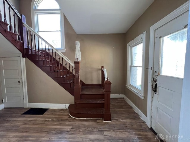 entrance foyer with stairway, wood finished floors, and baseboards