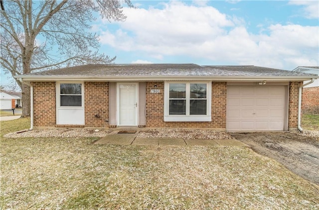 ranch-style home with a garage, brick siding, driveway, and a front lawn