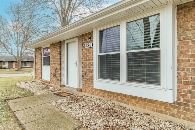 doorway to property with brick siding