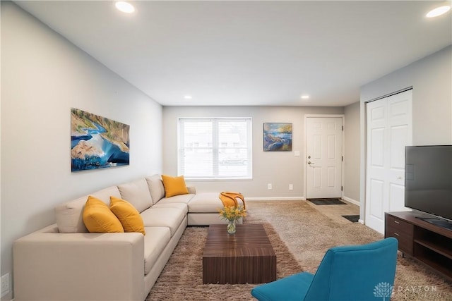 living room featuring carpet, baseboards, and recessed lighting