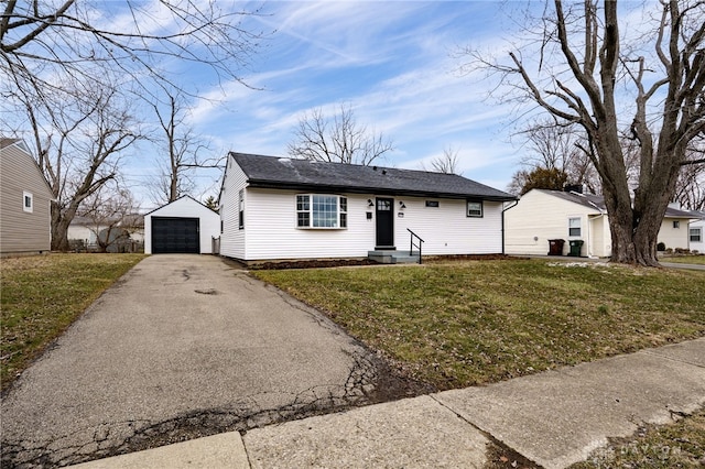 view of front of house featuring driveway, a detached garage, roof with shingles, an outdoor structure, and a front yard