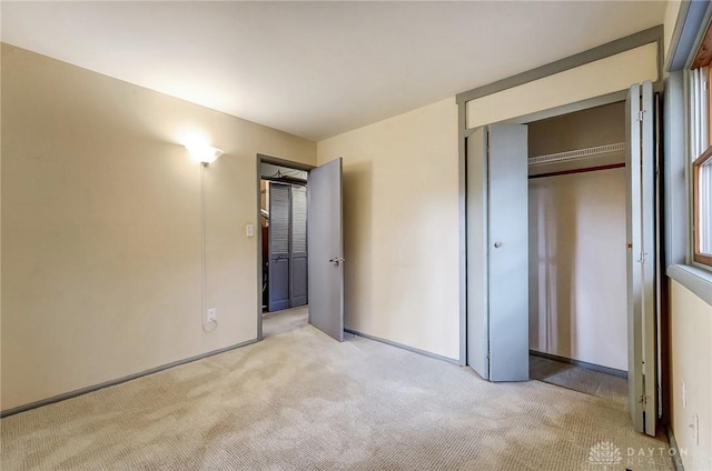 unfurnished bedroom featuring carpet, a closet, and baseboards