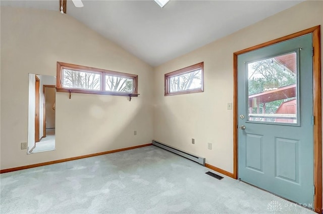 foyer entrance with carpet, lofted ceiling, visible vents, baseboard heating, and baseboards