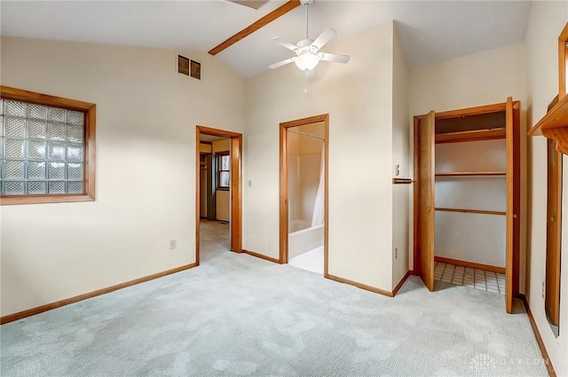 unfurnished bedroom with lofted ceiling, visible vents, baseboards, and carpet flooring