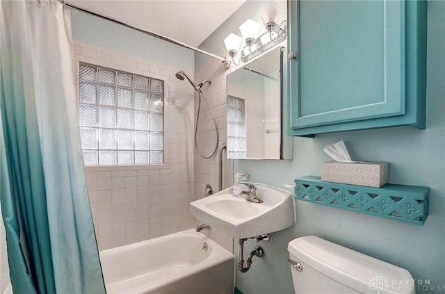 bathroom with shower / tub combo, a sink, and toilet