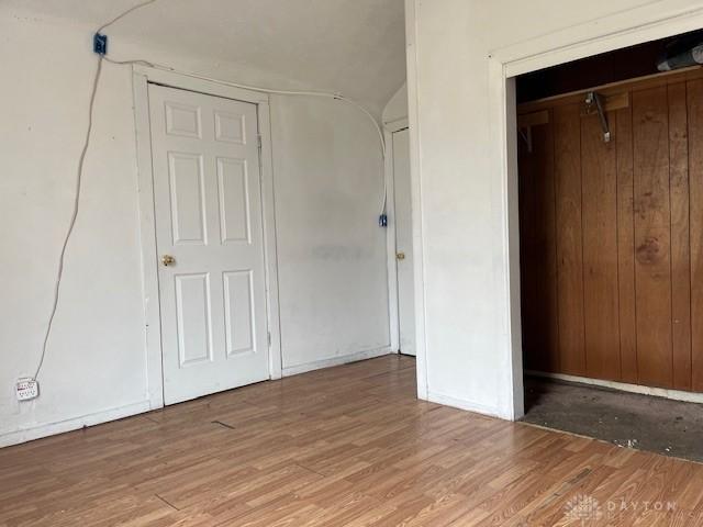 unfurnished bedroom featuring light wood-style floors and baseboards