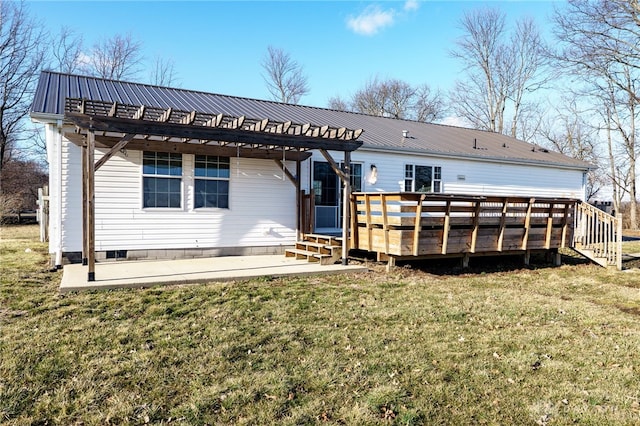 rear view of property with a deck, metal roof, a patio, a yard, and a pergola