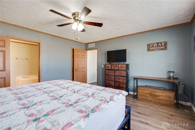 bedroom with baseboards, visible vents, ornamental molding, wood finished floors, and a textured ceiling