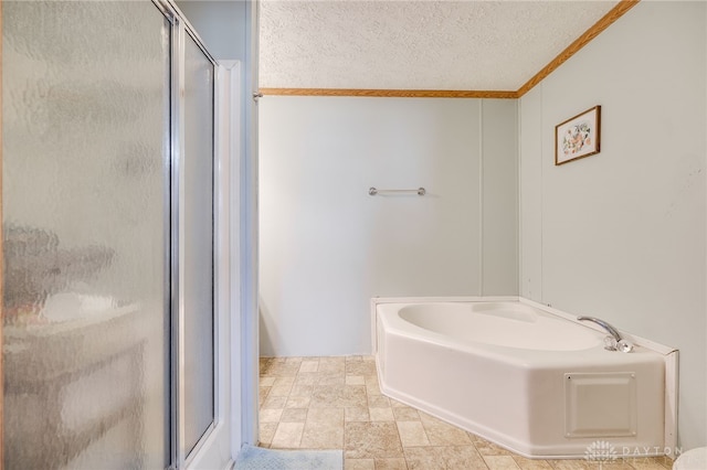 bathroom featuring stone finish floor, a garden tub, a shower stall, and a textured ceiling