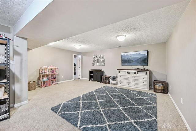 bedroom with a textured ceiling, carpet floors, and baseboards