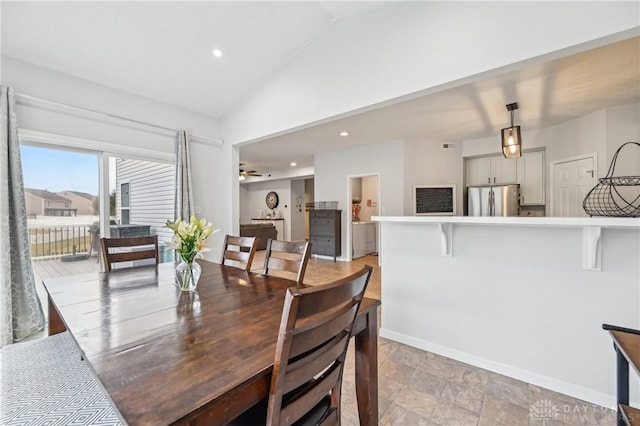 dining space with lofted ceiling, baseboards, and recessed lighting