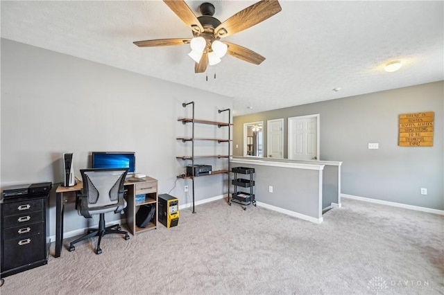 office area featuring a ceiling fan, carpet, baseboards, and a textured ceiling