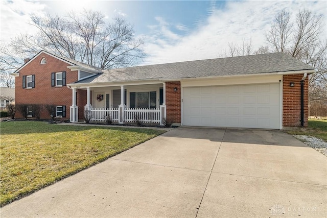 split level home featuring an attached garage, covered porch, brick siding, driveway, and a front lawn