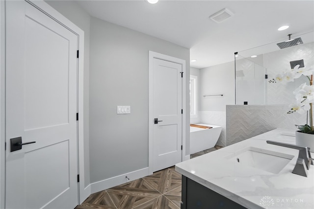 6976 Rosecliff Pl, Dayton, OH 45459 - bathroom featuring a walk in shower, a freestanding tub, double vanity, recessed lighting, and baseboards