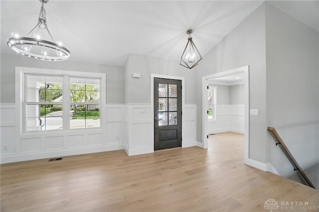 6976 Rosecliff Pl, Dayton, OH 45459 - foyer entrance with a chandelier, a decorative wall, light wood-type flooring, healthy amount of natural light, and wainscoting