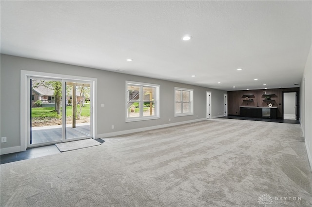 6976 Rosecliff Pl, Dayton, OH 45459 - unfurnished living room with baseboards, plenty of natural light, carpet, and recessed lighting