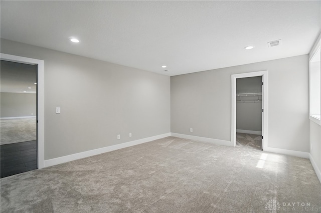 6976 Rosecliff Pl, Dayton, OH 45459 - unfurnished bedroom with carpet floors, a spacious closet, baseboards, and recessed lighting