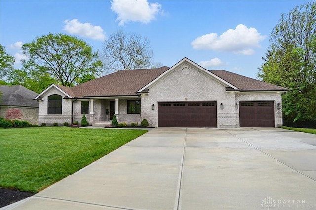 6976 Rosecliff Pl, Dayton, OH 45459 - view of front of home with an attached garage, a front lawn, driveway, and brick siding