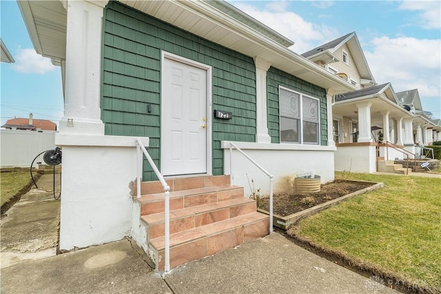 property entrance with a lawn